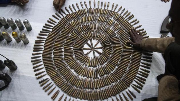 Police personnel display bullets during an arms laying ceremony by cadres of National Democratic Front of Bodoland (NDFB) in Guwahati, Assam. The insurgent group was responding to the government’s peace initiative to rejoin mainstream society. (Anupam Nath / AP)