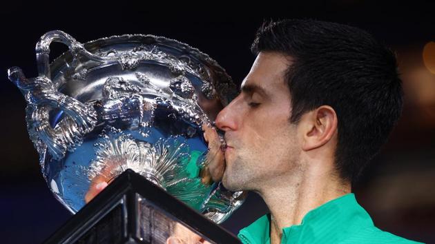Tennis - Australian Open - Men's Singles Final - Melbourne Park, Melbourne, Australia - February 3, 2020. Serbia's Novak Djokovic kisses the trophy after winning his match against Austria's Dominic Thiem. REUTERS/Kai Pfaffenbach TPX IMAGES OF THE DAY (REUTERS) Tennis - Australian Open - Men's Singles Final - Melbourne Park, Melbourne, Australia - February 3, 2020. Serbia's Novak Djokovic kisses the trophy after winning his match against Austria's Dominic Thiem. REUTERS/Kai Pfaffenbach TPX IMAGES OF THE DAY (REUTERS)