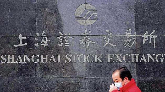 A man wearing a mask at the Shanghai Stock Exchange. The index closed down 7.7% at 2,746.6, its lowest since August. (Reuters image) A man wearing a mask at the Shanghai Stock Exchange. The index closed down 7.7% at 2,746.6, its lowest since August. (Reuters image)