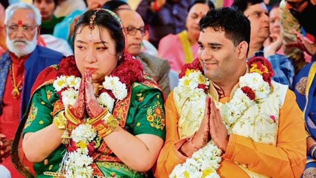 Zhihao Wang, the bride, and Satyarth Mishra during their wedding ceremony in Mandsaur on Sunday.(HT Photo)