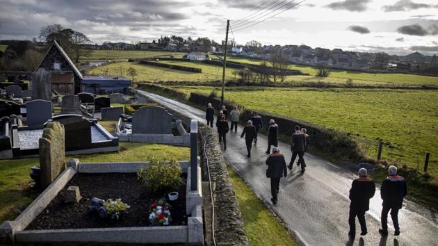 Members of the Orange Order march down the road in front of Drumcree Parish Church for their weekly protest in front of a waiting policeman who prevents them from continuing on through a Catholic area, in Portadown, Northern Ireland. The weekly protests have continued since 1998 when the Protestant group was last permitted to complete their traditional route through a Catholic area and is viewed by some groups as controversial. (David Goldman / AP) Members of the Orange Order march down the road in front of Drumcree Parish Church for their weekly protest in front of a waiting policeman who prevents them from continuing on through a Catholic area, in Portadown, Northern Ireland. The weekly protests have continued since 1998 when the Protestant group was last permitted to complete their traditional route through a Catholic area and is viewed by some groups as controversial. (David Goldman / AP)