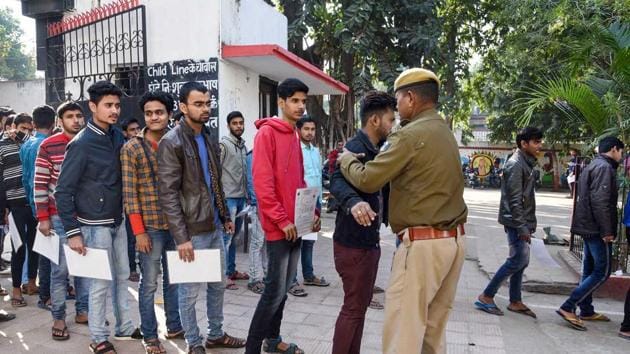 Security personnel frisk examinees before entering the examination hall in Patna on Monday. To prevent cheating, CCTV cameras have been put in place as lakhs of students across Bihar are appearing for the BSEB Board Exam 2020.(PTI)