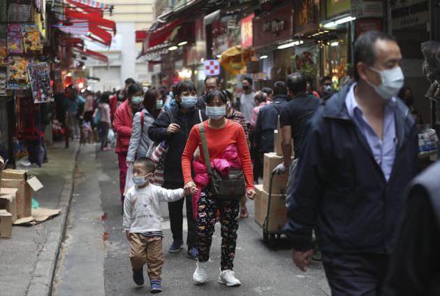 People visit the open market wearing face masks in hopes to prevent contracting the spreading coronavirus in Hong Kong,(AP)