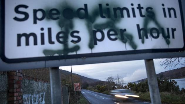 A sign on the border between Northern Ireland and the Republic of Ireland, spray painted with the initials of the Irish Republican Army, alerts drivers to the change in miles per hour for speed limit postings, in Newry, Northern Ireland. The only way motorists know they have crossed into Northern Ireland is from the speed limit signs, which use miles per hour measurements, rather than the metric system used in the south. (David Goldman / AP) A sign on the border between Northern Ireland and the Republic of Ireland, spray painted with the initials of the Irish Republican Army, alerts drivers to the change in miles per hour for speed limit postings, in Newry, Northern Ireland. The only way motorists know they have crossed into Northern Ireland is from the speed limit signs, which use miles per hour measurements, rather than the metric system used in the south. (David Goldman / AP)