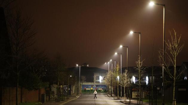 A pedestrian walks down a quiet street by one of the few remaining gates separating Catholic and Protestant neighbourhoods that still close each night, in Belfast, Northern Ireland. Signs of the conflict, known here as The Troubles, are still evident. In Belfast, so-called peace walls still seek to prevent violence by separating Protestant and Catholic neighbourhoods. (David Goldman / AP) A pedestrian walks down a quiet street by one of the few remaining gates separating Catholic and Protestant neighbourhoods that still close each night, in Belfast, Northern Ireland. Signs of the conflict, known here as The Troubles, are still evident. In Belfast, so-called peace walls still seek to prevent violence by separating Protestant and Catholic neighbourhoods. (David Goldman / AP)
