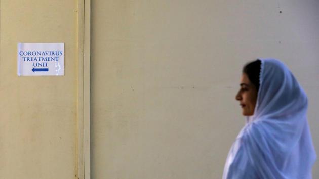 A paramedic staff stands outside an isolation section, set up for the precautionary measures for the coronavirus patients treatment, at the Jinnah Postgraduate Medical Center in Karachi.(REUTERS)