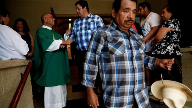 Father Guillermo Trevi-o says goodbye to people after leading a Spanish spoken church service in West Liberty. The predominantly white state has seen the Hispanic share of its population more than double to 6.2% since 2000, making it Iowa’s biggest minority group and a crucial voting bloc that could spell the difference in state caucuses and in the November election. (Eric Thayer / REUTERS)