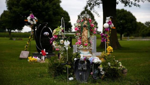 Flowers left at a gravesite, stand at the Oak Ridge Cemetery in West Liberty. The population growth has spurred many Democrats seeking the nomination to face President Donald Trump in November to hire Latino or Spanish-speaking staff and tailor some campaign events to court Latinos, while activists have scrambled to register new Hispanic voters and maximize their clout. (Eric Thayer / REUTERS)