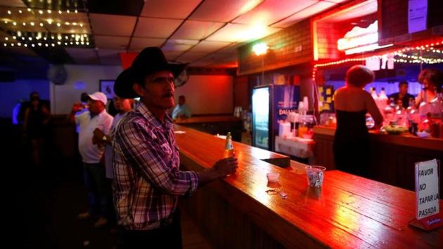 A man drinks a beer during a Quinceanera celebration at Flamas Night Club in West Liberty. Hispanic activists estimate as few as 3,000 Latinos participated in Iowa’s 2016 presidential caucuses, out of more than 50,000 who were registered to vote. (Eric Thayer / REUTERS)