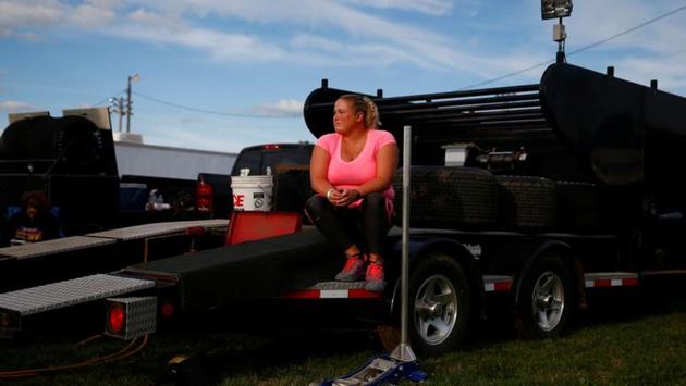 A woman sits on a race car trailer at the West Liberty Race Track in West Liberty. The crowded field of Democratic presidential contenders has made up for it in this campaign, however, heavily courting Latinos in the state ahead of a general election campaign likely to be influenced by Trump’s divisive rhetoric and policies on immigration. (Eric Thayer / REUTERS)