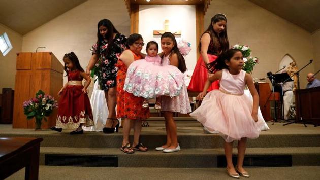 A young girl is carried down steps during a Spanish spoken church service at St. Joseph Catholic Church in West Liberty. “I’ll be the first to admit that we have not done as much as we need to as a party to organise and emphasize the Latino vote,” said Troy Price, chairman of the Iowa Democratic Party, who said the party was trying to bolster its Hispanic appeal with new staff and programs. (Eric Thayer / REUTERS)