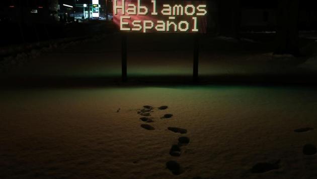 A lit up sign reading 'We speak Spanish' in Spanish, stands outside a dental clinic. With the Hispanic population expected to more than double again by 2050, according to the State Data Center of Iowa, Salazar said the community was trying to build a tradition of civic engagement. “When people think about rural Iowa they think of white farmers, but many of these communities will keep becoming more diverse and more Latino,” Salazar said. (Eric Thayer / REUTERS)