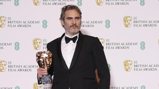 Joaquin Phoenix poses with his award for Leading Actor for Joker at the British Academy of Film and Television Awards (BAFTA) at the Royal Albert Hall in London.(REUTERS)