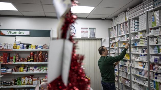 Pharmacist Tom Murray, 46, stocks shelves at his pharmacy in Castlefinn, Ireland, just over the border from Northern Ireland. “My historical political view, I think Ireland should always be united country and should be free of the shackles of Britain. But at the same time, we have to accept that there’s one million people living a mile away who identify as British,” said Murray, adding that their Britishness must be protected as much as his Irishness. (David Goldman / AP) Pharmacist Tom Murray, 46, stocks shelves at his pharmacy in Castlefinn, Ireland, just over the border from Northern Ireland. “My historical political view, I think Ireland should always be united country and should be free of the shackles of Britain. But at the same time, we have to accept that there’s one million people living a mile away who identify as British,” said Murray, adding that their Britishness must be protected as much as his Irishness. (David Goldman / AP)