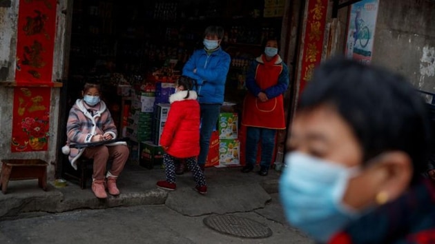 People wear protective masks in an old neighbourhood of Jiujiang, Jiangxi province, China, as the country is hit by an outbreak of novel coronavirus. February 2, 2020. (REUTERS) People wear protective masks in an old neighbourhood of Jiujiang, Jiangxi province, China, as the country is hit by an outbreak of novel coronavirus. February 2, 2020. (REUTERS)