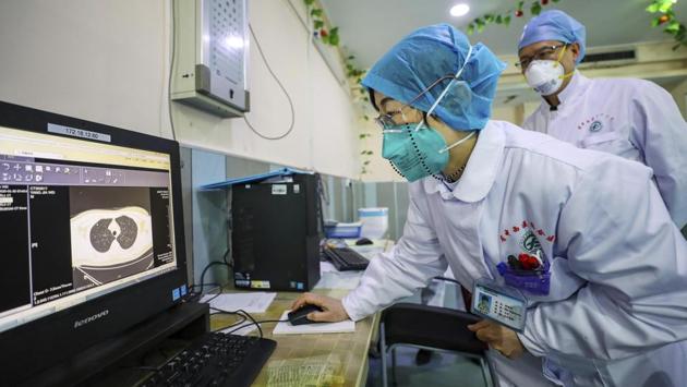 Doctors look at a CT scan of a patient at a hospital in Wuhan. With no end in sight to the outbreak, authorities in Hubei and elsewhere extended the Lunar New Year holiday break, due to end this week, well into February to try to keep people at home and reduce the spread of the virus. All Hubei schools are postponing the start of the new semester until further notice. (AP)