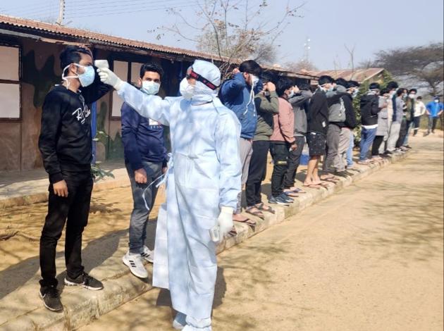 A medical staff scans the temperature of Indian National who arrived from coronavirus-hit Wuhan, put for medical observation, at quarantine center, in Manesar. (Photo: ANI) A medical staff scans the temperature of Indian National who arrived from coronavirus-hit Wuhan, put for medical observation, at quarantine center, in Manesar. (Photo: ANI)