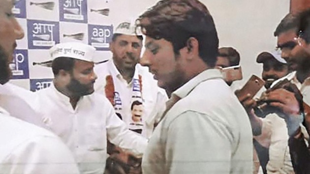 In this undated photo provided by Crime Branch, is seen Kapil Gujjar with Aam Aadmi Party (AAP) leaders. Gujjar who opened fired at Shaheen Bagh protest site last week is a member of the Aam Aadmi Party, police said. (PTI) In this undated photo provided by Crime Branch, is seen Kapil Gujjar with Aam Aadmi Party (AAP) leaders. Gujjar who opened fired at Shaheen Bagh protest site last week is a member of the Aam Aadmi Party, police said. (PTI)
