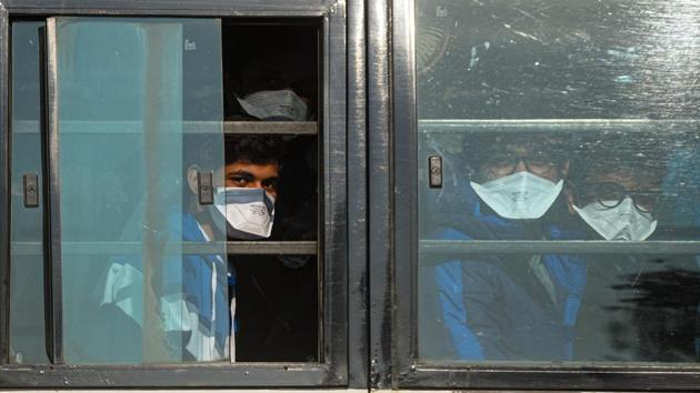 Students wearing masks as they are taken to a special army facility as a precaution against the possible coronavirus infection on their return from China, at Indira Gandhi International Airport, in New Delhi on February 1, 2020.(Amal KS/HT PHOTO)