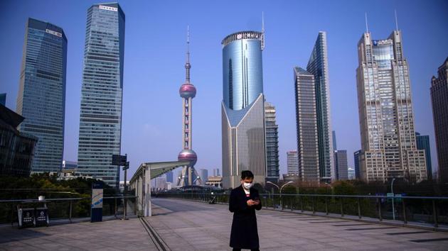 A man wearing a mask is seen at Lujiazui financial district in Pudong, Shanghai. First identified in Wuhan, the flu-like virus is believed to have originated at a city market selling wild animals. (Aly Song / REUTERS)