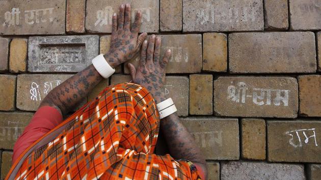 A woman devotee prays to the bricks reading "Shree Ram" ( Lord Ram), which are expected to be used in constructing the Ram temple, in Ayodhya.(AP) A woman devotee prays to the bricks reading "Shree Ram" ( Lord Ram), which are expected to be used in constructing the Ram temple, in Ayodhya.(AP)