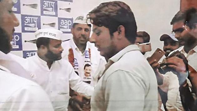 In this undated photo provided by Crime Branch, is seen Kapil Gujjar with Aam Aadmi Party (AAP) leaders. Gujjar who opened fired at Shaheen Bagh protest site last week is a member of the Aam Aadmi Party, police said.(PTI)