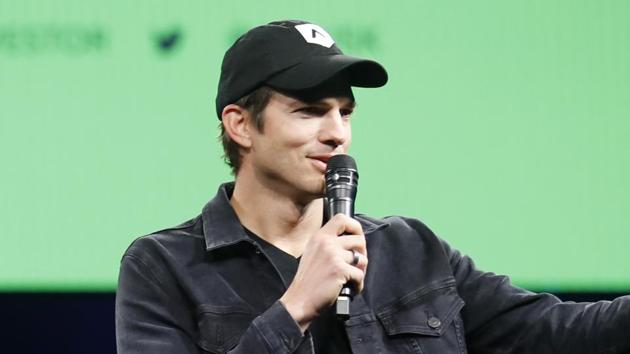 Actor and investor Ashton Kutcher, right, greets the crowd at Intuit's QuickBooks Connect 2019.(AP)