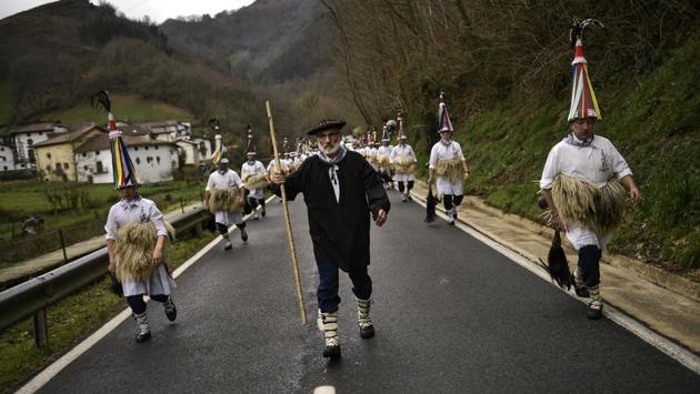 A group of “Joaldunak” march along the road as they take part in a Carnival. (Alvaro Barrientos / AP)