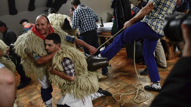 A “Joaldunak” is helped to adjust his cowbells before taking part in the traditional carnival. The groups, named “Joaldunak,” after the Basque-language word for cowbells, march through the northern towns of Ituren and Zubieta to herald the advent of spring. (Alvaro Barrientos / AP)