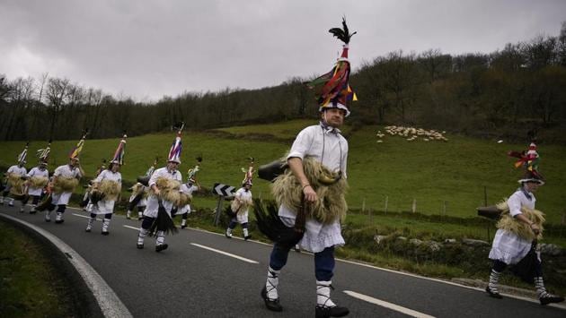 The participants march along roads and mountain paths between the two towns, jingling their bells. (Alvaro Barrientos / AP)