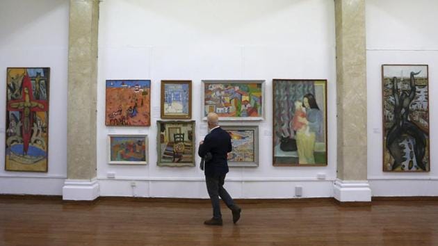 A man looks at paintings during an exhibition of culturally significant paintings that were recently exchanged as part of an effort to boost confidence between the ethnically divided island nation's two communities, at the Ledra Palace Hotel inside the UN controlled buffer zone in divided capital Nicosia, Cyprus, Monday, Feb. 3, 2020. Cyprus' President Nicos Anastasiades and the leader of the ethnically divided island's breakaway Turkish Cypriots Mustafa Akinci attended the exhibition.(AP/Petros Karadjias) A man looks at paintings during an exhibition of culturally significant paintings that were recently exchanged as part of an effort to boost confidence between the ethnically divided island nation's two communities, at the Ledra Palace Hotel inside the UN controlled buffer zone in divided capital Nicosia, Cyprus, Monday, Feb. 3, 2020. Cyprus' President Nicos Anastasiades and the leader of the ethnically divided island's breakaway Turkish Cypriots Mustafa Akinci attended the exhibition.(AP/Petros Karadjias)