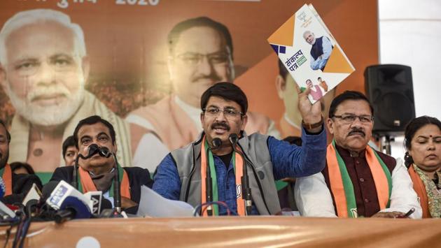 Union minister and BJP leader Nitin Gadkari (L) looks on as Delhi BJP President Manoj Tiwari shows the ‘BJP Sankalp Patra’ for Delhi Assembly Elections 2020, after its launch in New Delhi. The election campaign broadly revolved around distinct themes for the different parties. (Kamal Singh / PTI)