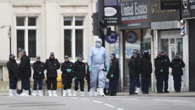 Police officers work at the scene following a terror stabbing attack in the Streatham area of south London. Police in London say the man identified as 20-year-old Sudesh Amman was wearing a fake bomb and stabbed two people before being shot to death by police. Amman was recently released from prison, where he was serving for terrorism offenses. (Aaron Chown/ PA via AP)