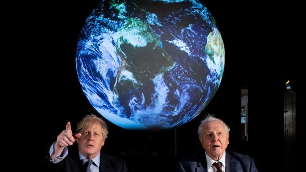 British Prime Minister Boris Johnson and natural historian David Attenborough speak with school children during a conference about the UK-hosted COP26 UN Climate Summit, at the Science Museum in London. (Chris J Ratcliffe / REUTERS)