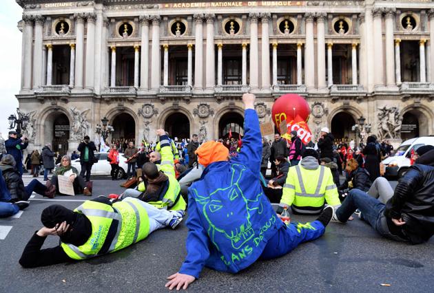 People gather outside the Opera Garnier in Paris after Public sector unions CGT, FAFP, FO, FSU et Solidaires called for a day of action to demand “the remain of the social gains in terms of painfulness at work”, as part of the global protest against the government pensions reform. (Alain Jocard / AFP)