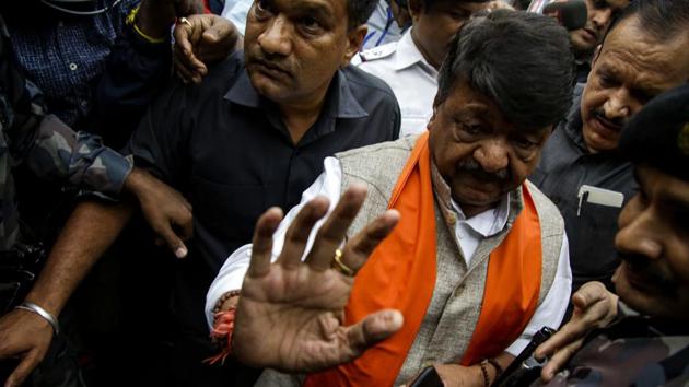 Kailash Vijaywargiya, of Bharatiya Janata Party (BJP), talks to a police officer before he was detained while participating in a rally supporting a new citizenship law. (AP) Kailash Vijaywargiya, of Bharatiya Janata Party (BJP), talks to a police officer before he was detained while participating in a rally supporting a new citizenship law. (AP)