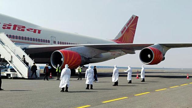 Medical officials during the screening of 323 Indians and 7 Maldives citizens, that took off from the coronavirus outbreak city Wuhan (China) in Air India special flight and landed at Delhi airport, on Sunday. (ANI photo) Medical officials during the screening of 323 Indians and 7 Maldives citizens, that took off from the coronavirus outbreak city Wuhan (China) in Air India special flight and landed at Delhi airport, on Sunday. (ANI photo)