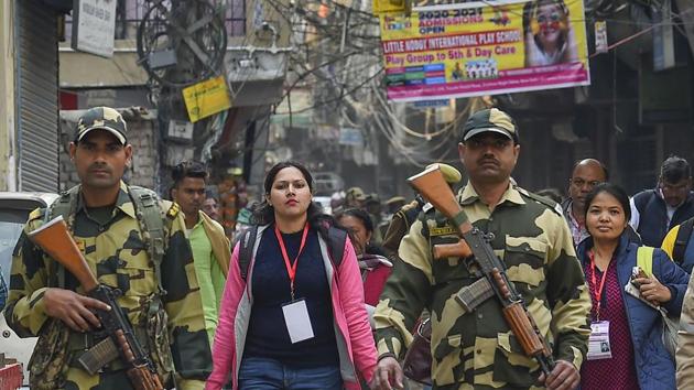 Poll officials arrive amid tight security at a polling station on the eve of Delhi Assembly elections, at Shaheen Bagh in New Delhi. (PTI) Poll officials arrive amid tight security at a polling station on the eve of Delhi Assembly elections, at Shaheen Bagh in New Delhi. (PTI)