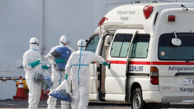 Officers wearing protective suits carry plastic bags next to an ambulance, near the cruise ship Diamond Princess, where 10 more people were tested positive for coronavirus on Thursday, at Daikoku Pier Cruise Terminal in Yokohama, south of Tokyo, Japan. (Reuters image) Officers wearing protective suits carry plastic bags next to an ambulance, near the cruise ship Diamond Princess, where 10 more people were tested positive for coronavirus on Thursday, at Daikoku Pier Cruise Terminal in Yokohama, south of Tokyo, Japan. (Reuters image)