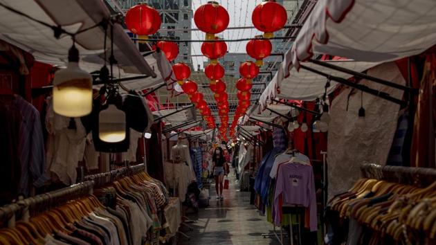 A shopper walks in a street market aimed for Chinese tourists. “It’s still too early to know what the long-term economic impact of the coronavirus could be, and it may be some time before we know the full extent,” Tourism Minister Kelvin Davis told AP. “The government is taking this very seriously, and we are closely monitoring the situation.” (Gemunu Amarasinghe / AP)