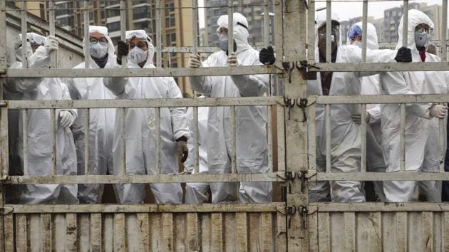 In this Thursday, Feb. 6, 2020, photo, workers in protective suits ride on a truck carrying medical supplies into Huoshenshan temporary hospital built for patients who diagnosed with 2019-nCoV in Wuhan in central China's Hubei province. (AP) In this Thursday, Feb. 6, 2020, photo, workers in protective suits ride on a truck carrying medical supplies into Huoshenshan temporary hospital built for patients who diagnosed with 2019-nCoV in Wuhan in central China's Hubei province. (AP)