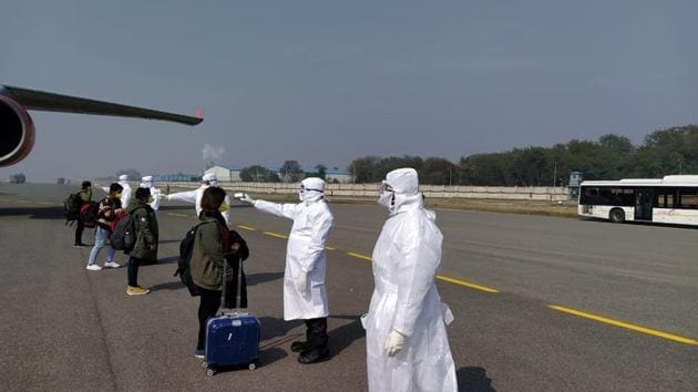 Medical officials screen passengers for coronavirus who de-boarded from the Air India special flight after landing at Indira Gandhi International Airport in New Delhi. The officials screened 323 Indians and 7 Maldives citizens who took off from Wuhan – the epicenter of coronavirus outbreak. (ITBP / HT Photo)