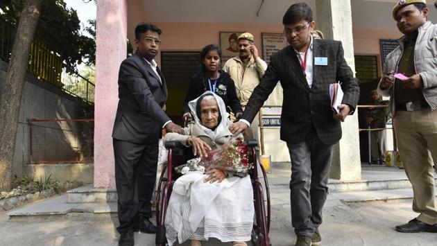 Kalitara Mandal, 111 years old, leaves after casting her vote at a polling station in CR Park on February 8. Mandal is the oldest voter in Delhi Assembly election. (Sanjeev Verma / HT Photo)