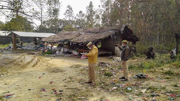 Policemen inspect the site where seven people, including three children were killed after inhaling poisonous gas in a carpet factory at Jalalpur village in Sitapur, Uttar Pradesh. (PTI)