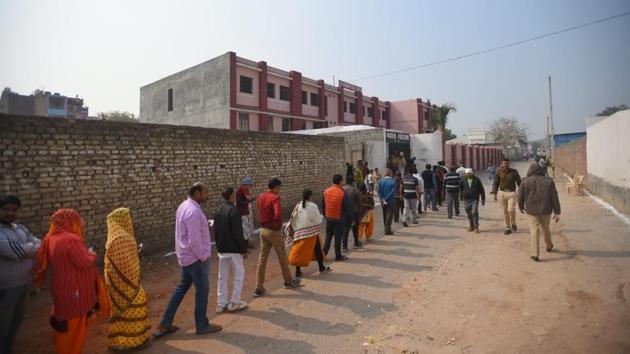 People queue to cast their vote at Badarpur. Voting closed at 6pm and the voter turnout recorded stood at 54.65%. However, those who have queued up in the polling booths will be allowed to vote. The total voter turnout was 67.12% in the last Assembly polls held in 2015. (Amal KS / HT Photo)