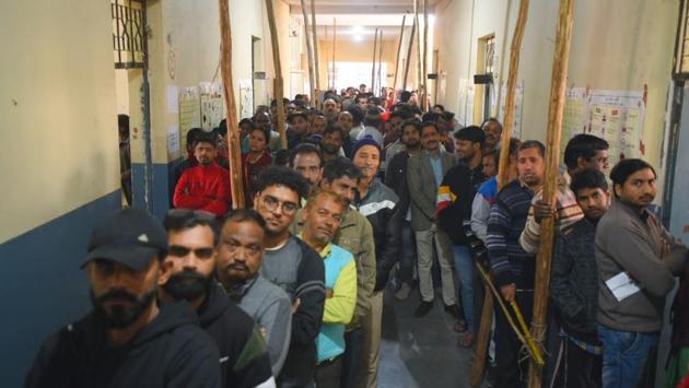 People stand in queue to cast their vote at Badarpur. More than 14.7 million voters are eligible to exercise their franchise in the Delhi assembly election. There are 81,05,236 male voters, 66,80,277 female voters and 869 third gender voters. (Amal KS / HT Photo)