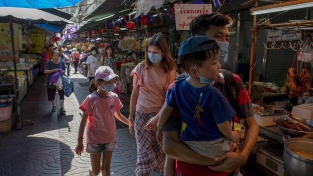 Asian tourists walk in an alleyway of China town in Bangkok. Thailand, a long established tourist market, is in the top rank for Chinese visitors, who comprised 11 million, or 27%, of the total 40 million tourists to visit the country last year. (Gemunu Amarasinghe / AP)