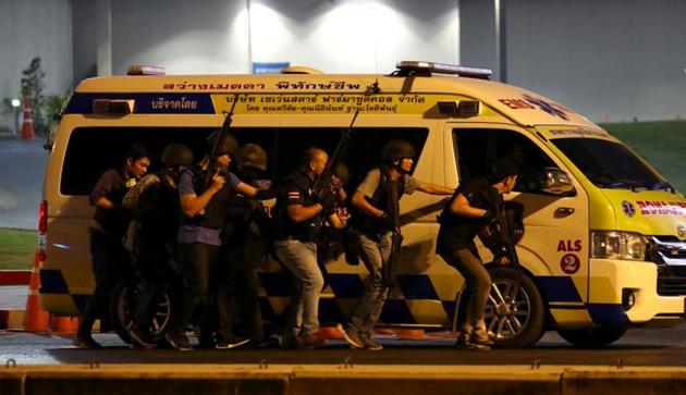 Thailand security forces take cover behind an ambulance as they chase a shooter hidden in a shopping mall after a mass shooting in front of the Terminal 21, in Nakhon Ratchasima, Thailand February 9, 2020. (REUTERS) Thailand security forces take cover behind an ambulance as they chase a shooter hidden in a shopping mall after a mass shooting in front of the Terminal 21, in Nakhon Ratchasima, Thailand February 9, 2020. (REUTERS)