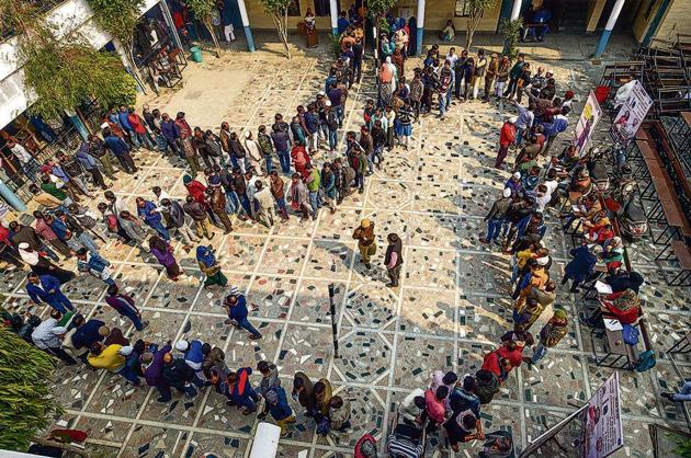 People wait in queues to cast their votes at Shaheen Public School polling station in the Shaheen Bagh area, which has been witnessing a peaceful protest against the Citizenship Act for several weeks, during the Delhi Assembly elections, in New Delhi, Saturday, Feb. 8, 2020.(PTI)