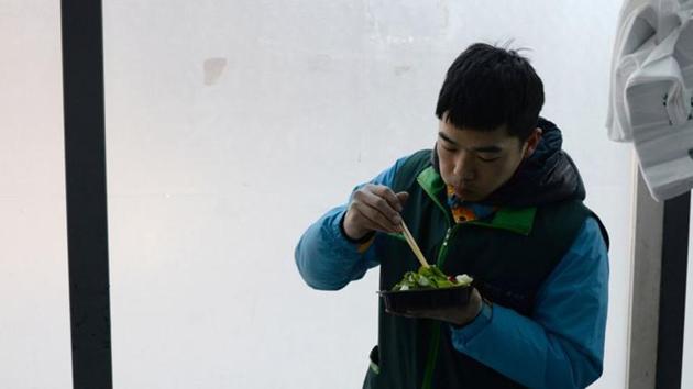 Guo Qiang, a 29-year-old deliveryman for Dada-JD Daojia, eats lunch at a sorting point for online orders from a JD.com's 7Fresh chain, as the country is hit by an outbreak of the novel coronavirus, in Yizhuang town, Beijing. (REUTERS) Guo Qiang, a 29-year-old deliveryman for Dada-JD Daojia, eats lunch at a sorting point for online orders from a JD.com's 7Fresh chain, as the country is hit by an outbreak of the novel coronavirus, in Yizhuang town, Beijing. (REUTERS)